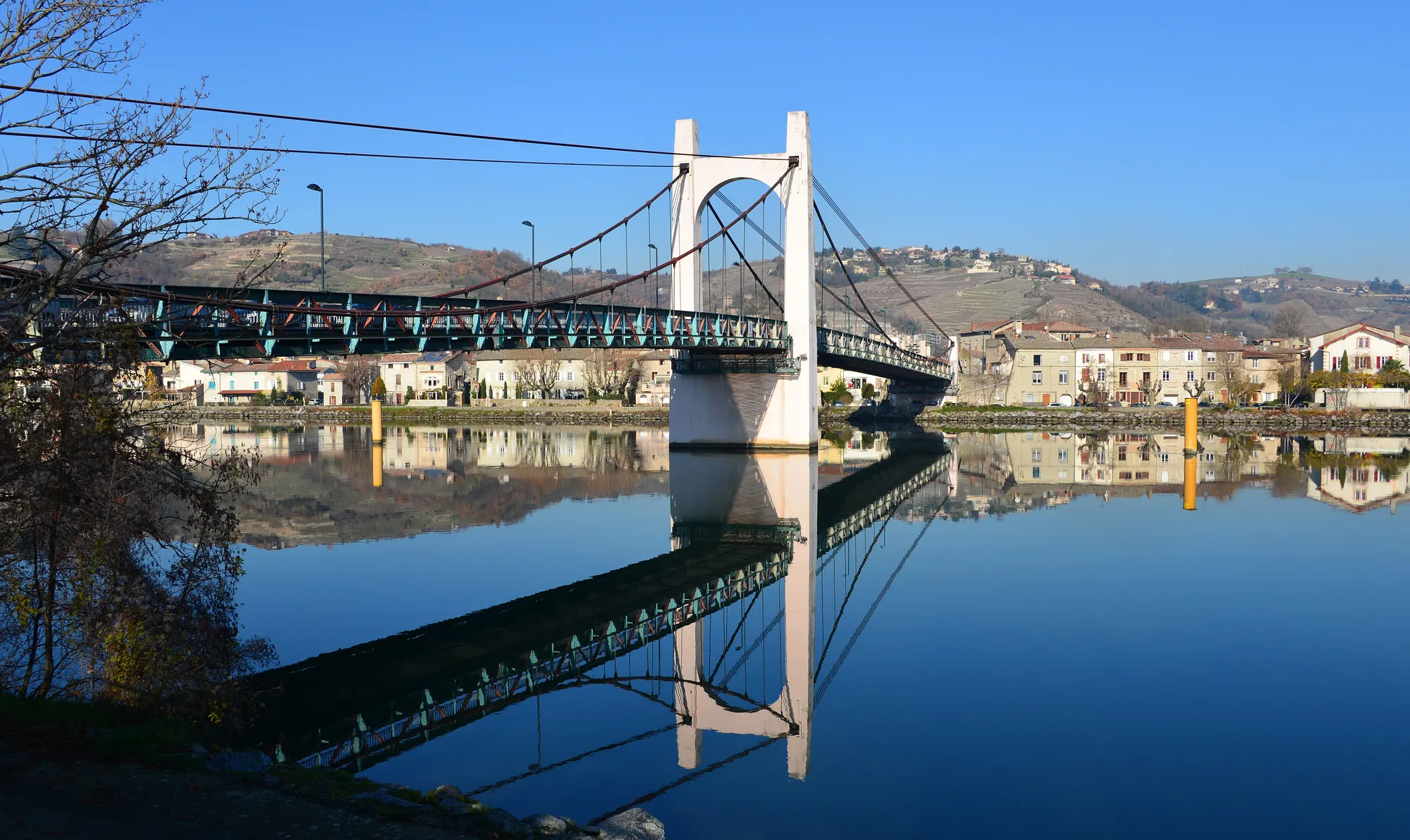 Le pont suspendu de Condrieu sur le Rhône, avec le village et les coteaux de vignes